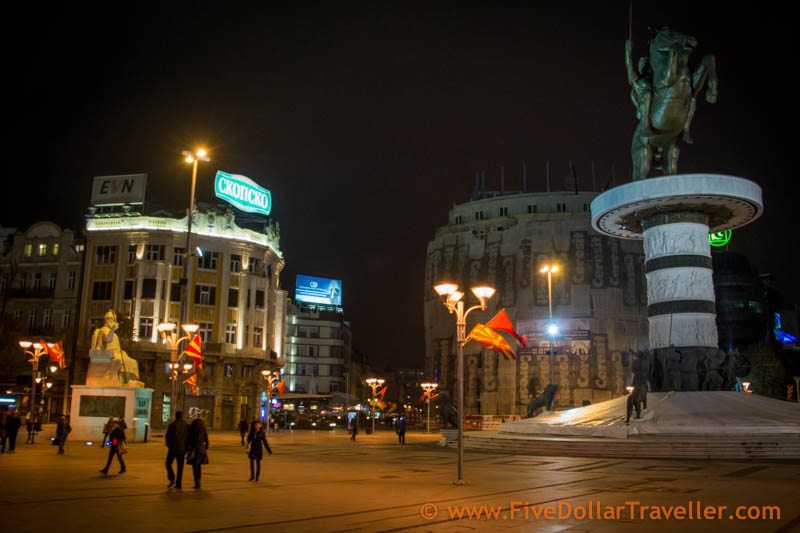 Skopje Podcast - Alexander statue with beer sign behind it.